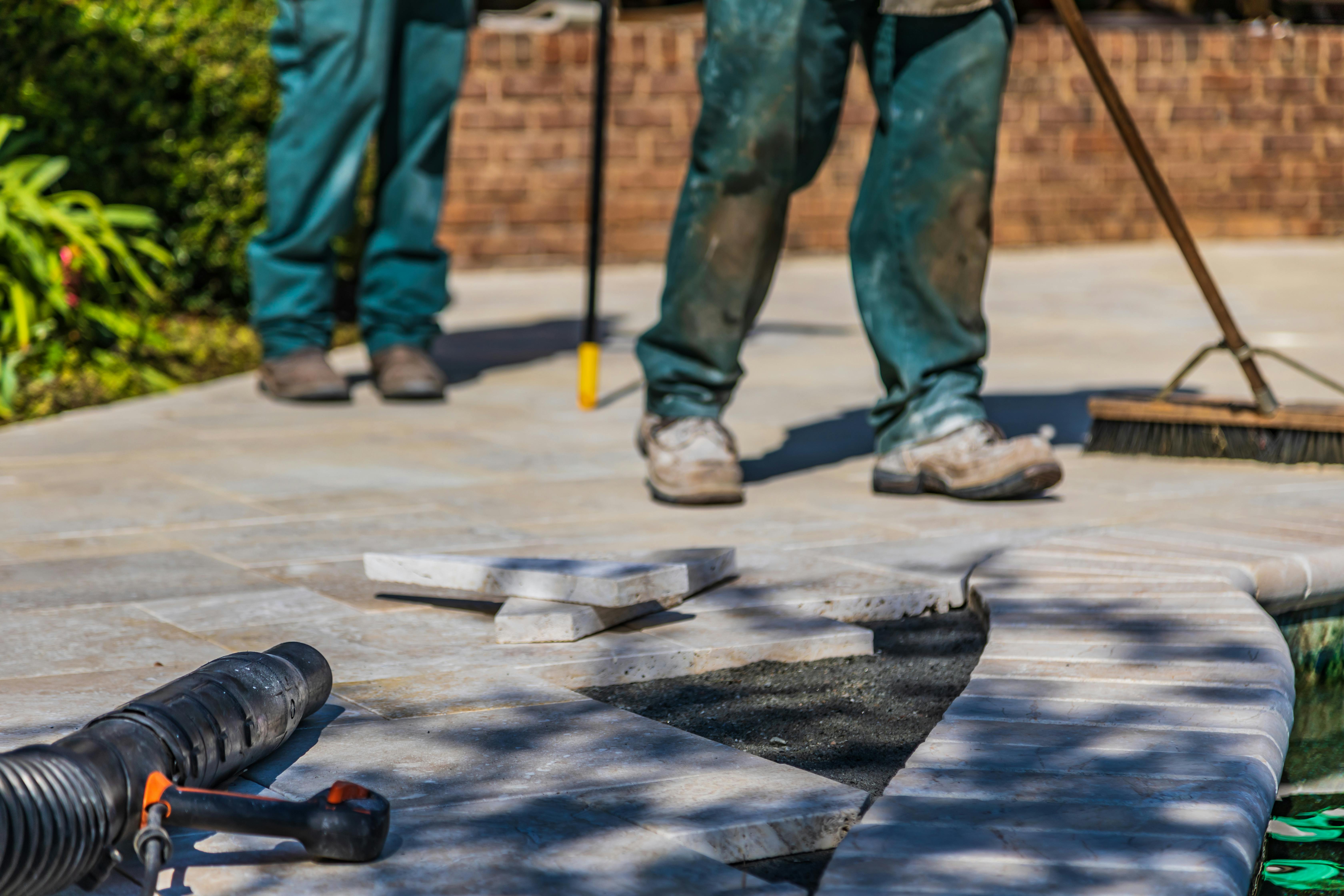 property%20managers%20doing%20maintenance%20on%20a%20stone%20walkway Property managers doing maintenance on a stone walkway